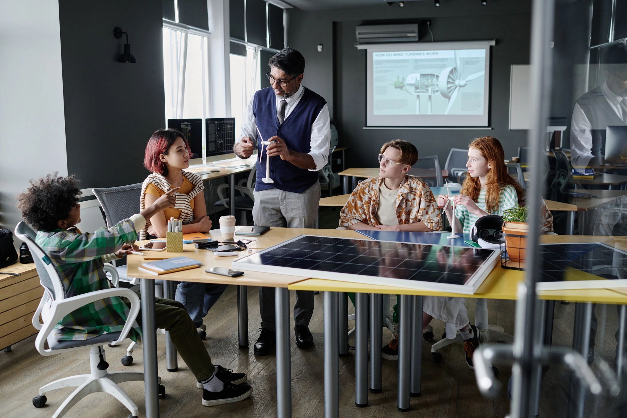 Mature Teacher Telling About Wind Turbines
